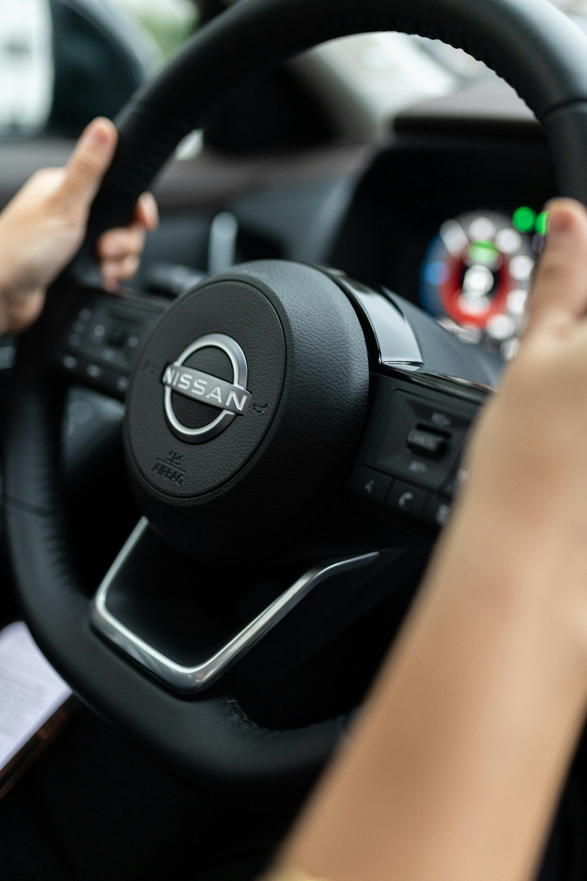 a person driving a car with a steering wheel