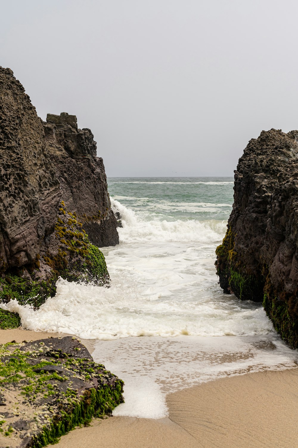 a sandy beach next to a large body of water