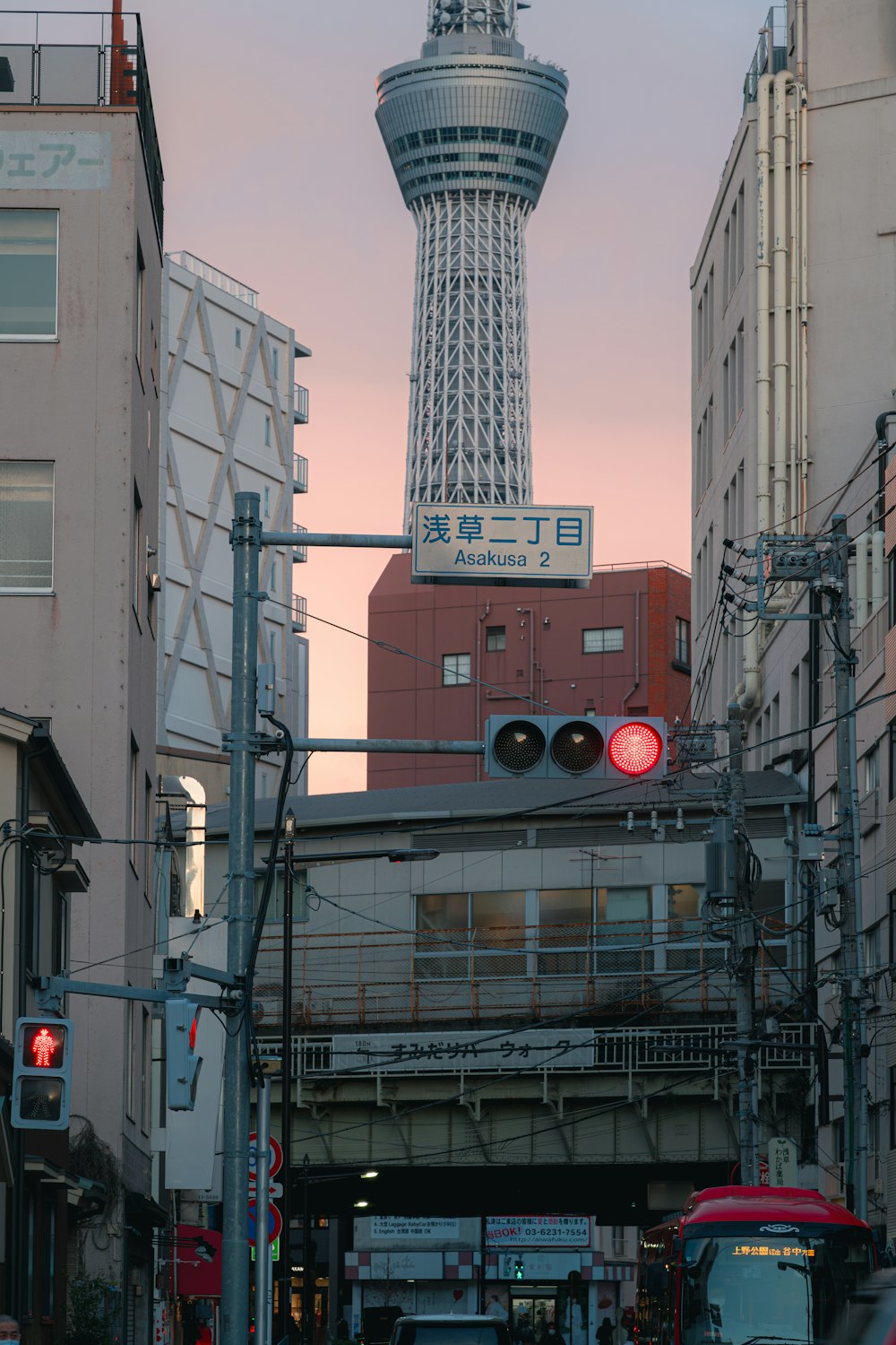 a traffic light on a city street with a tower in the background