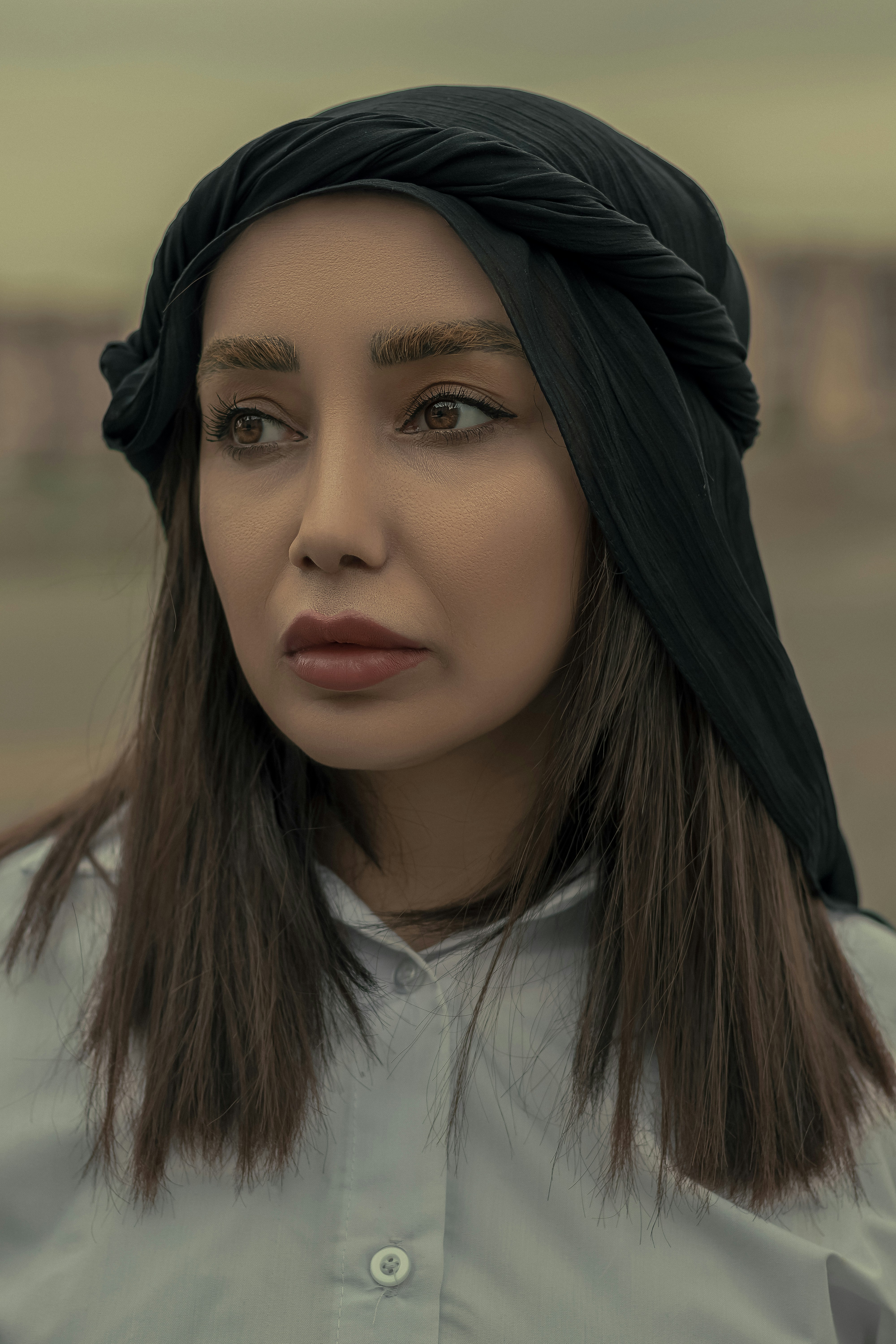 a woman with a black head scarf on her head