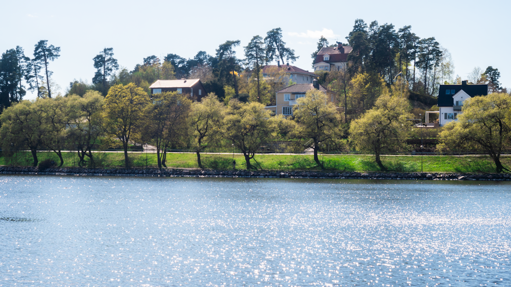 a body of water with houses in the background