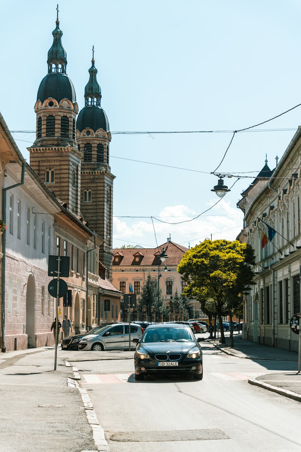 a car driving down a street next to tall buildings