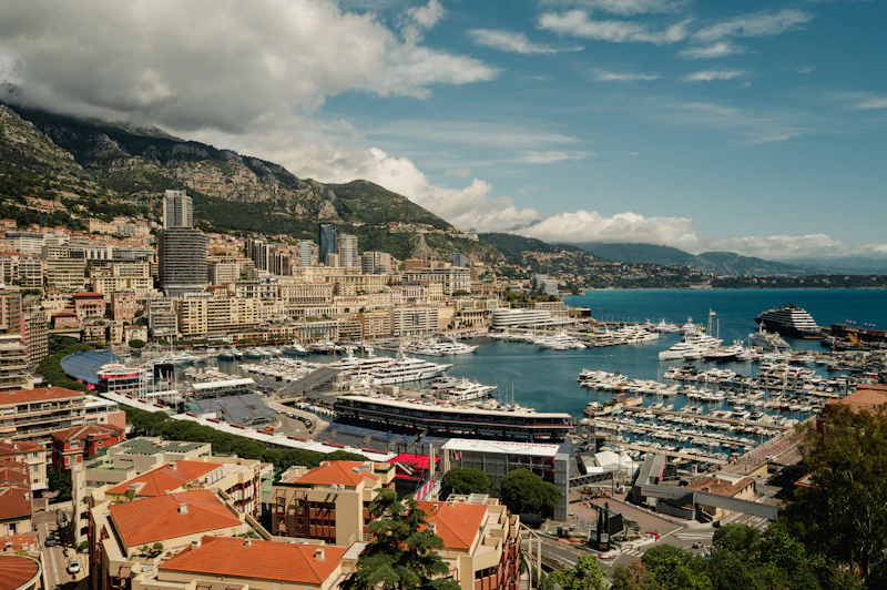 Superyachts moored in Monaco's harbour beneath the city, set for Grand Prix weekend