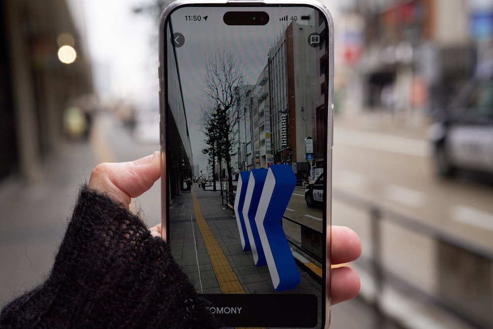 a person taking a picture of a street with their cell phone