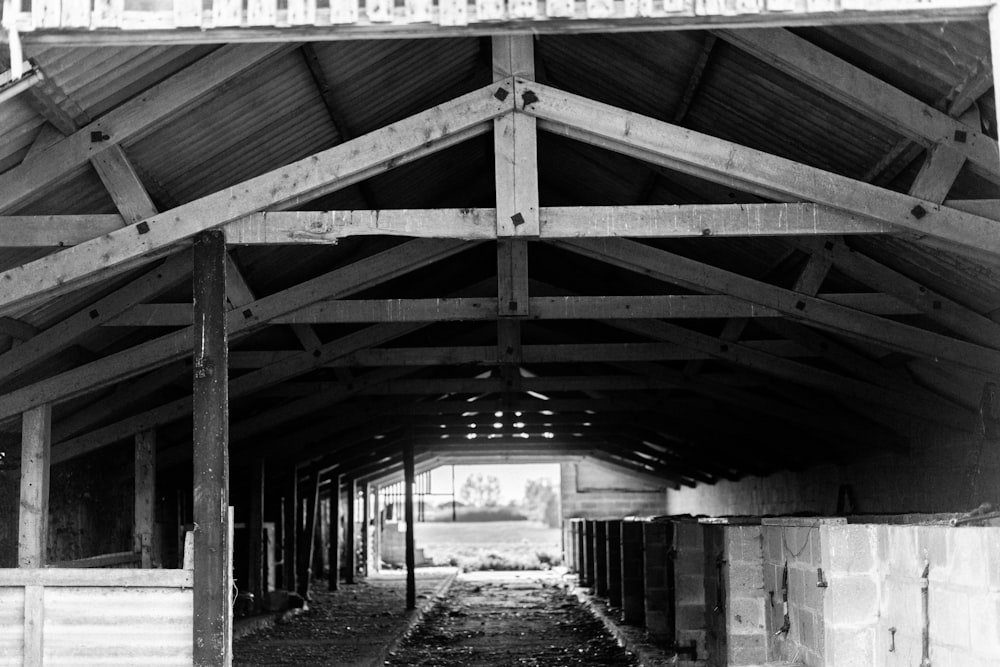 a black and white photo of a horse barn