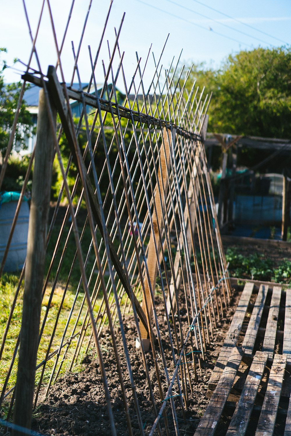 a fence made of metal rods and wood planks
