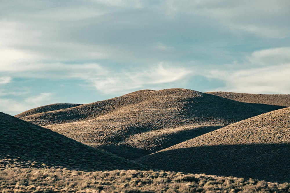 a large hill with a sky in the background