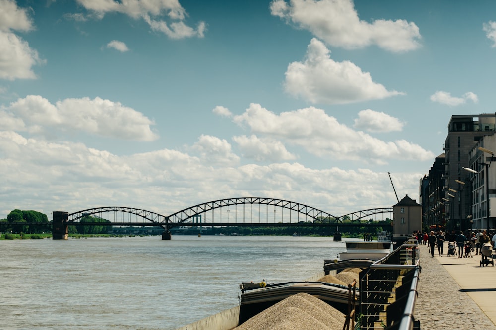 a bridge over a body of water with people walking on it