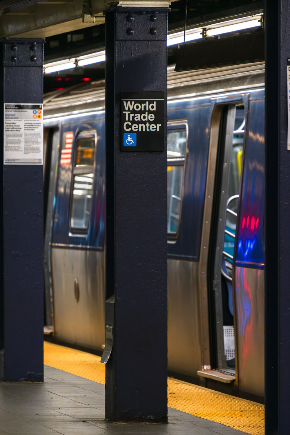 a subway train stopped at a train station