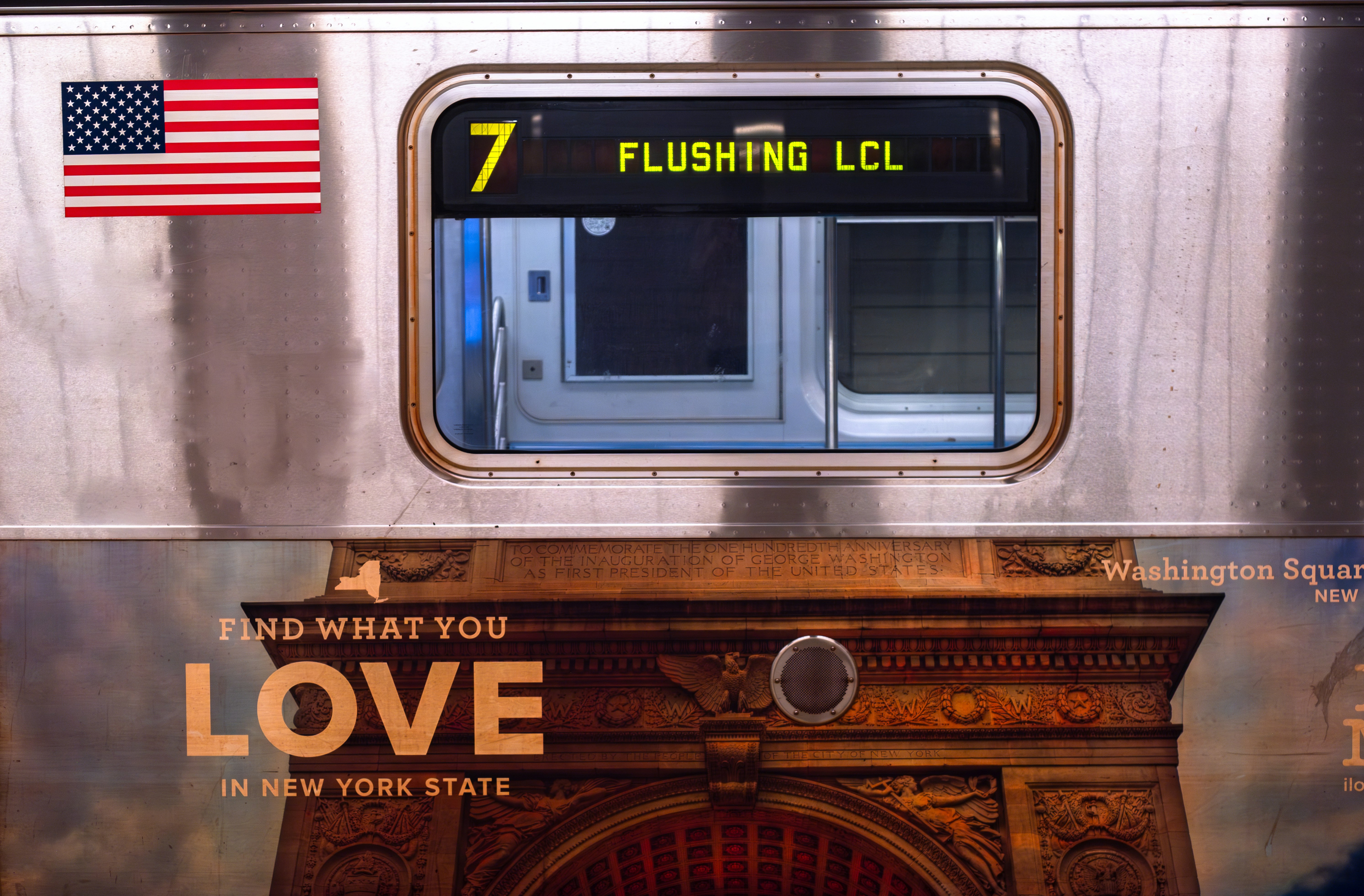 a silver train with a love sign on it, Flushing Local Train at Hudson Yards Subway Station