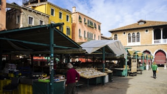a man walking down a street next to a building