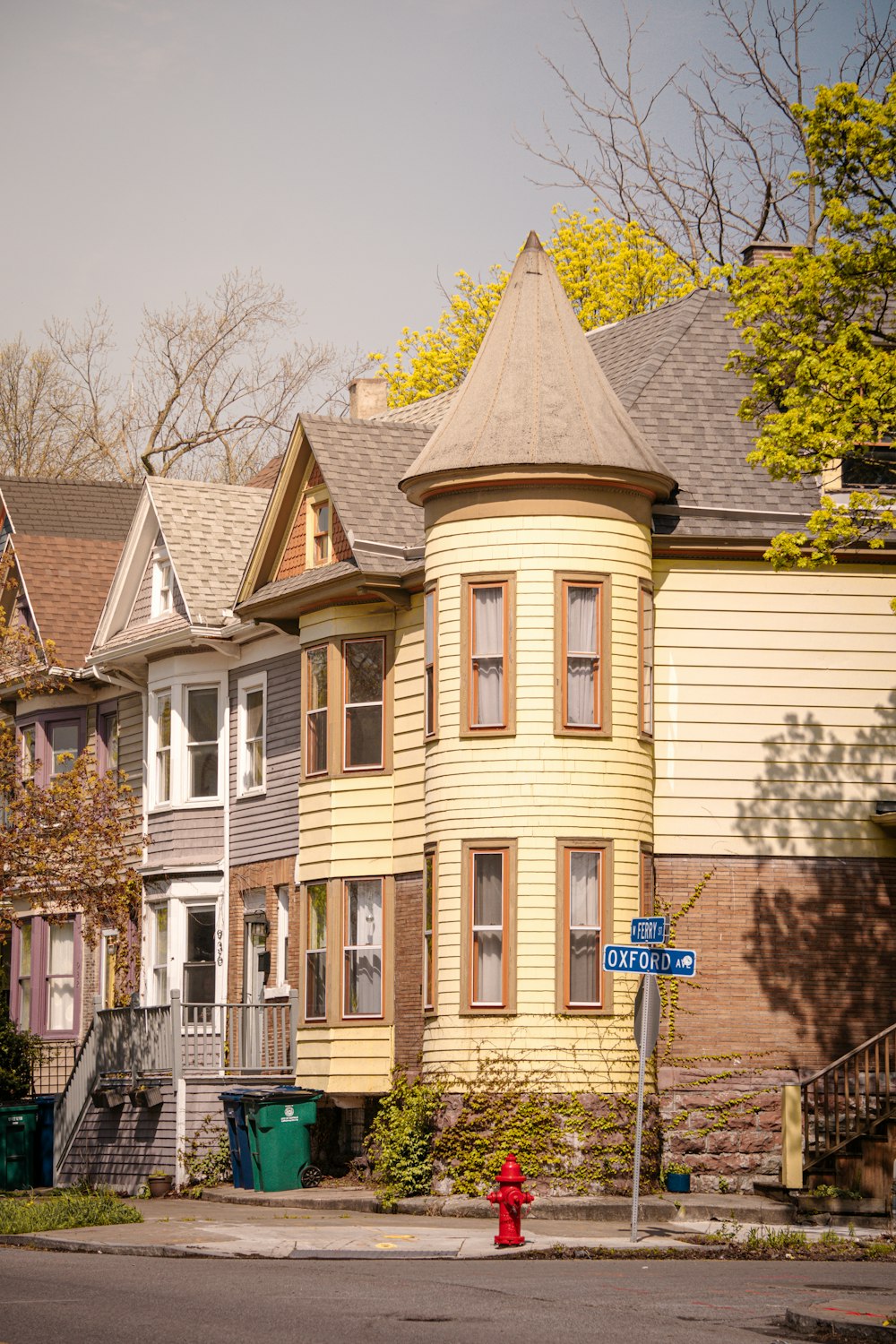 a yellow house with a red fire hydrant in front of it