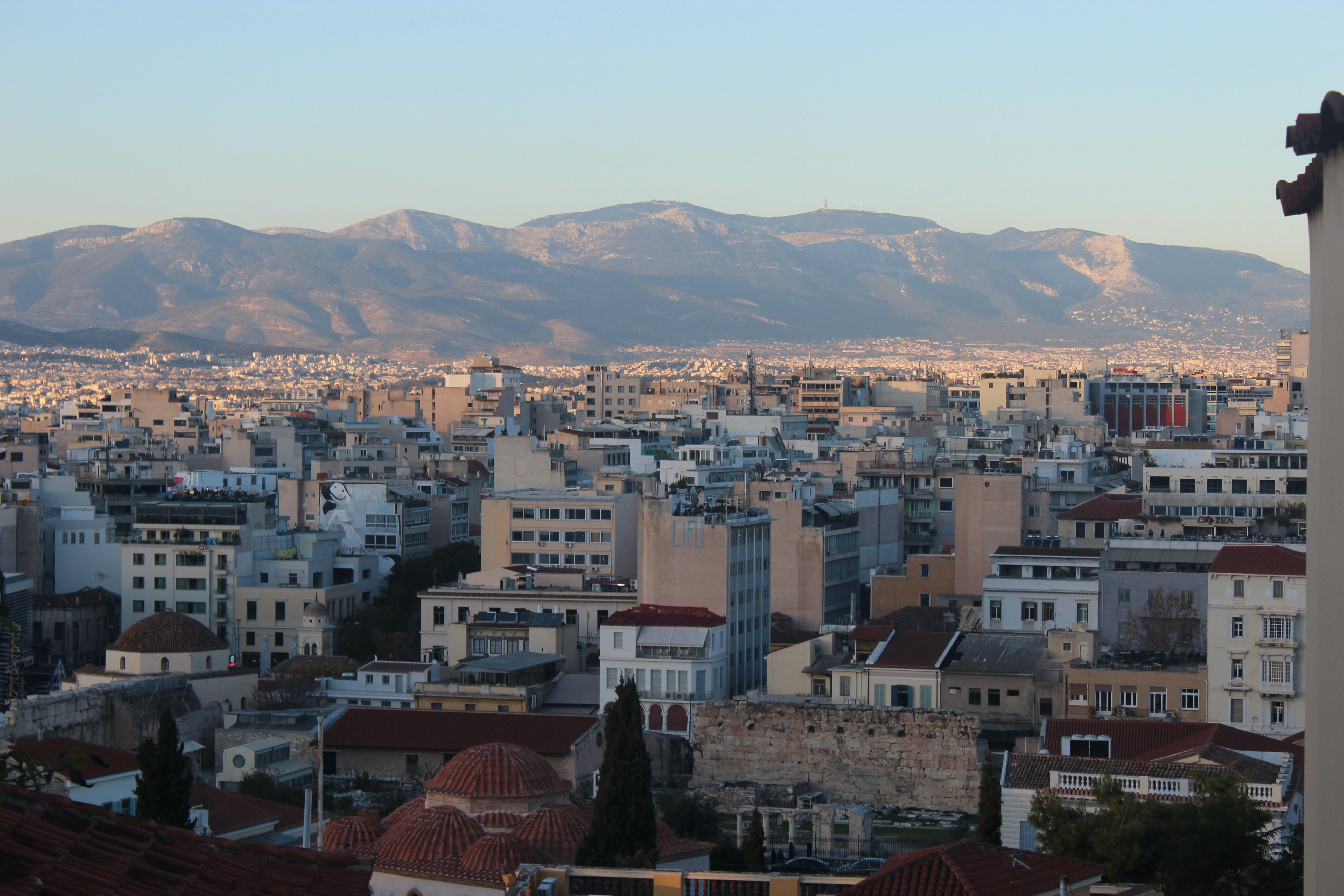 a view of a city with mountains in the background