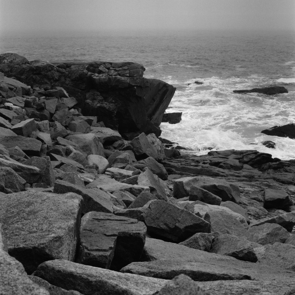 a black and white photo of a rocky beach