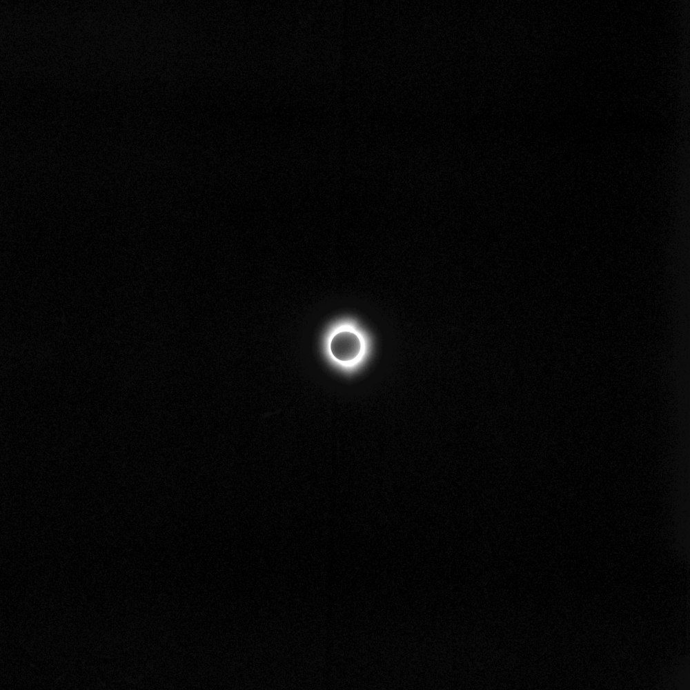 a black and white photo of a solar eclipse
