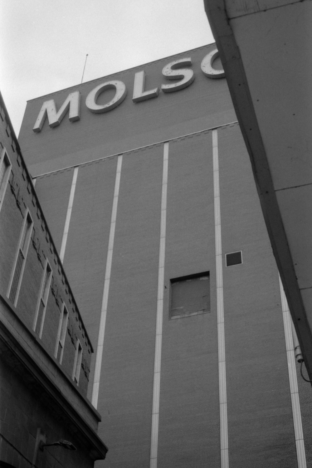 a black and white photo of a building with the word molsco on it