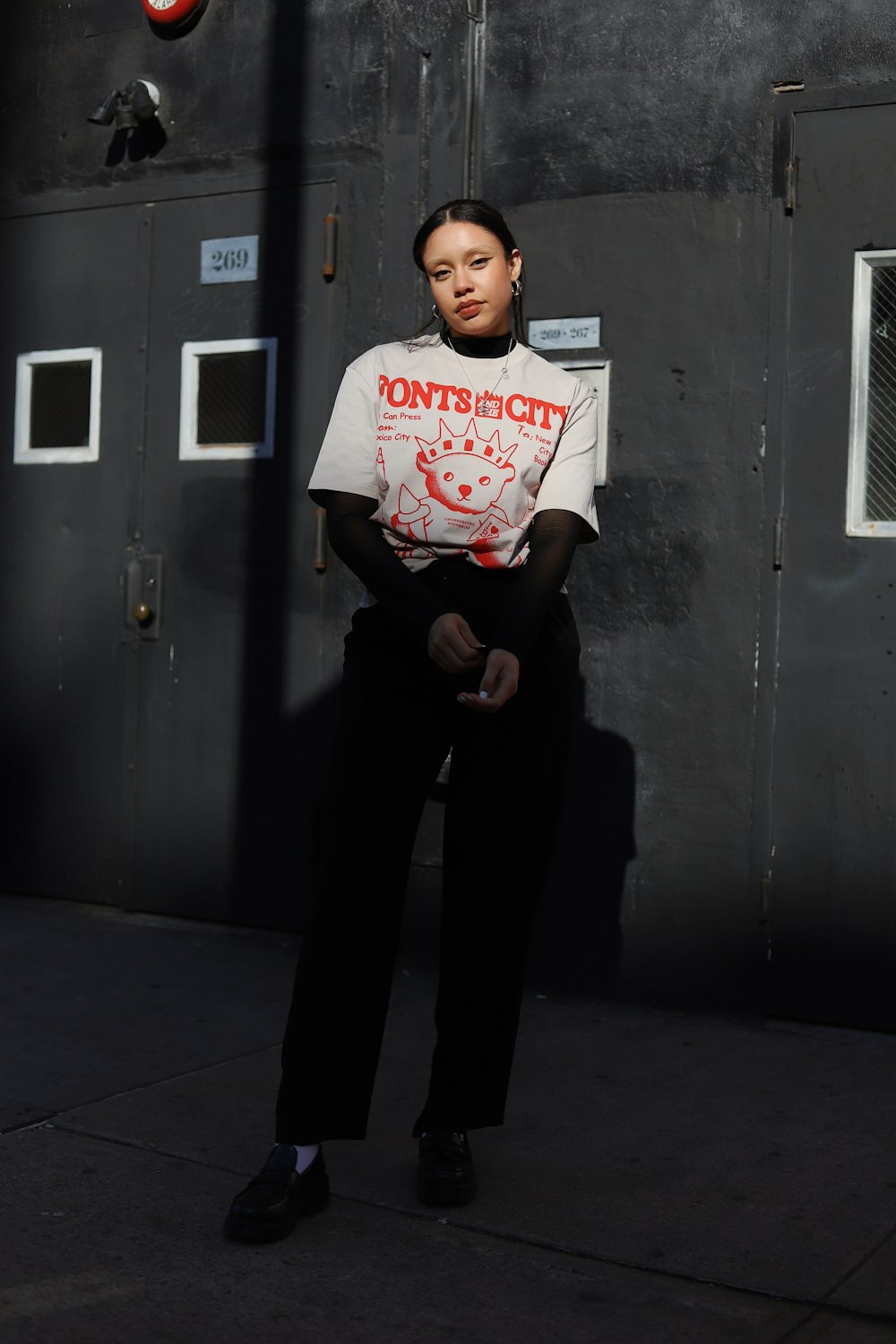 a woman sitting on a bench in front of a door