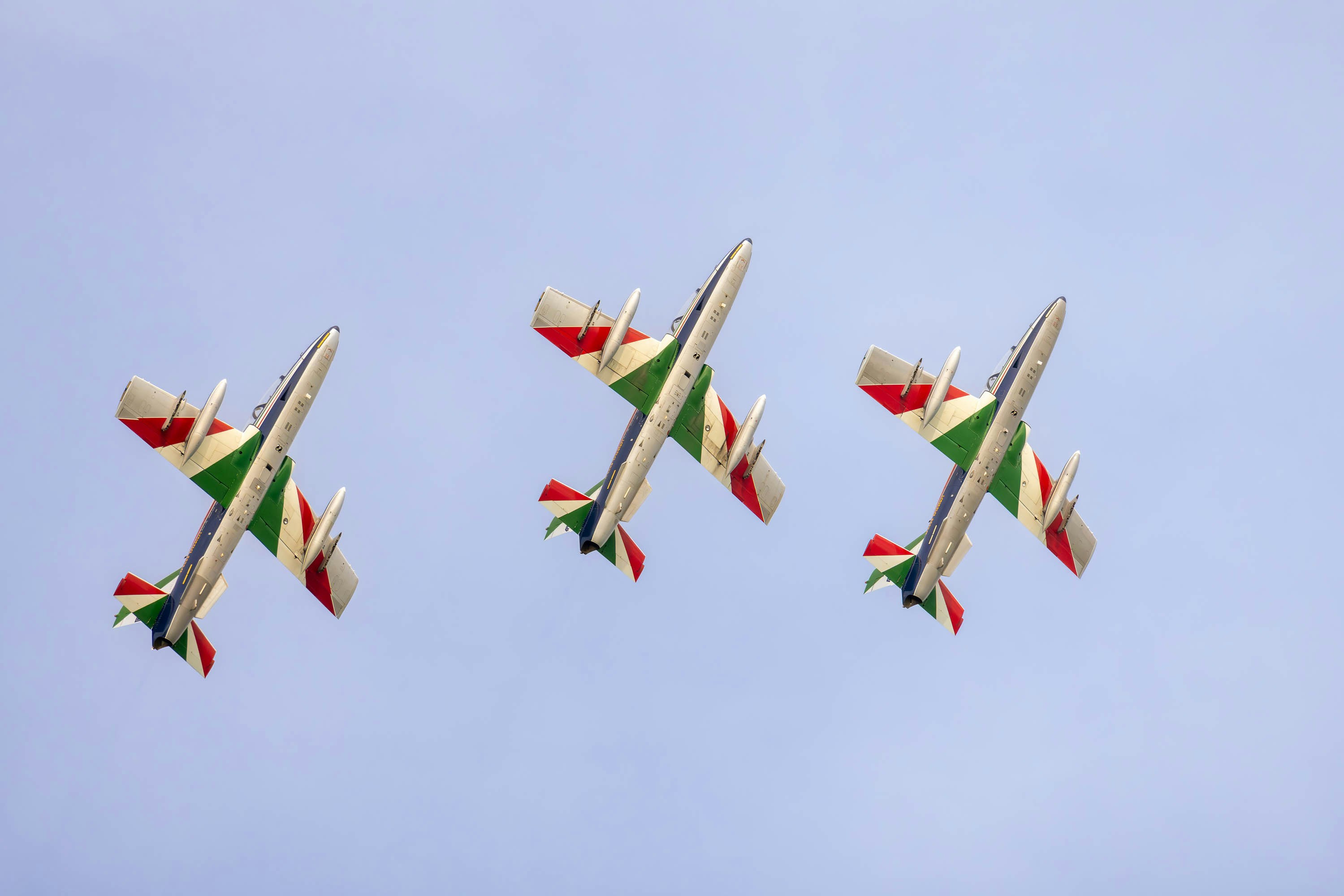 a group of airplanes flying in formation in the sky, The Italian national aerobatic team with MB339 aircraft of the Italian Air Force, performs over the skies of Caorle (Venice) for the airshow of 4 May 2024.