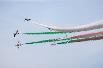 a group of airplanes flying through a blue sky