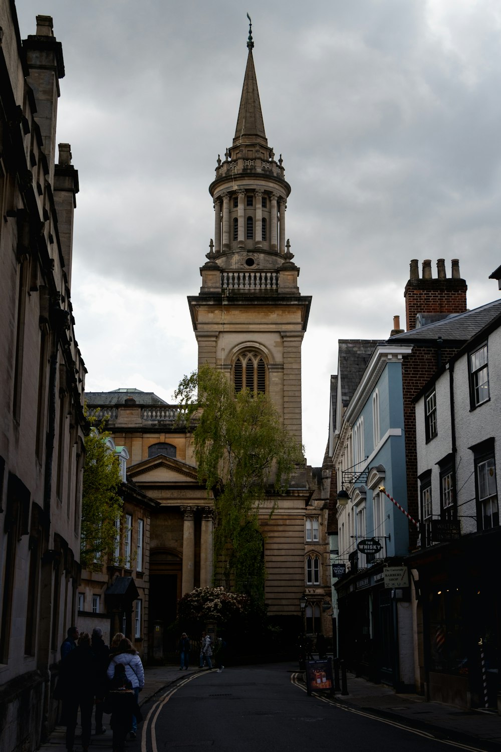 a church steeple towering over a city street