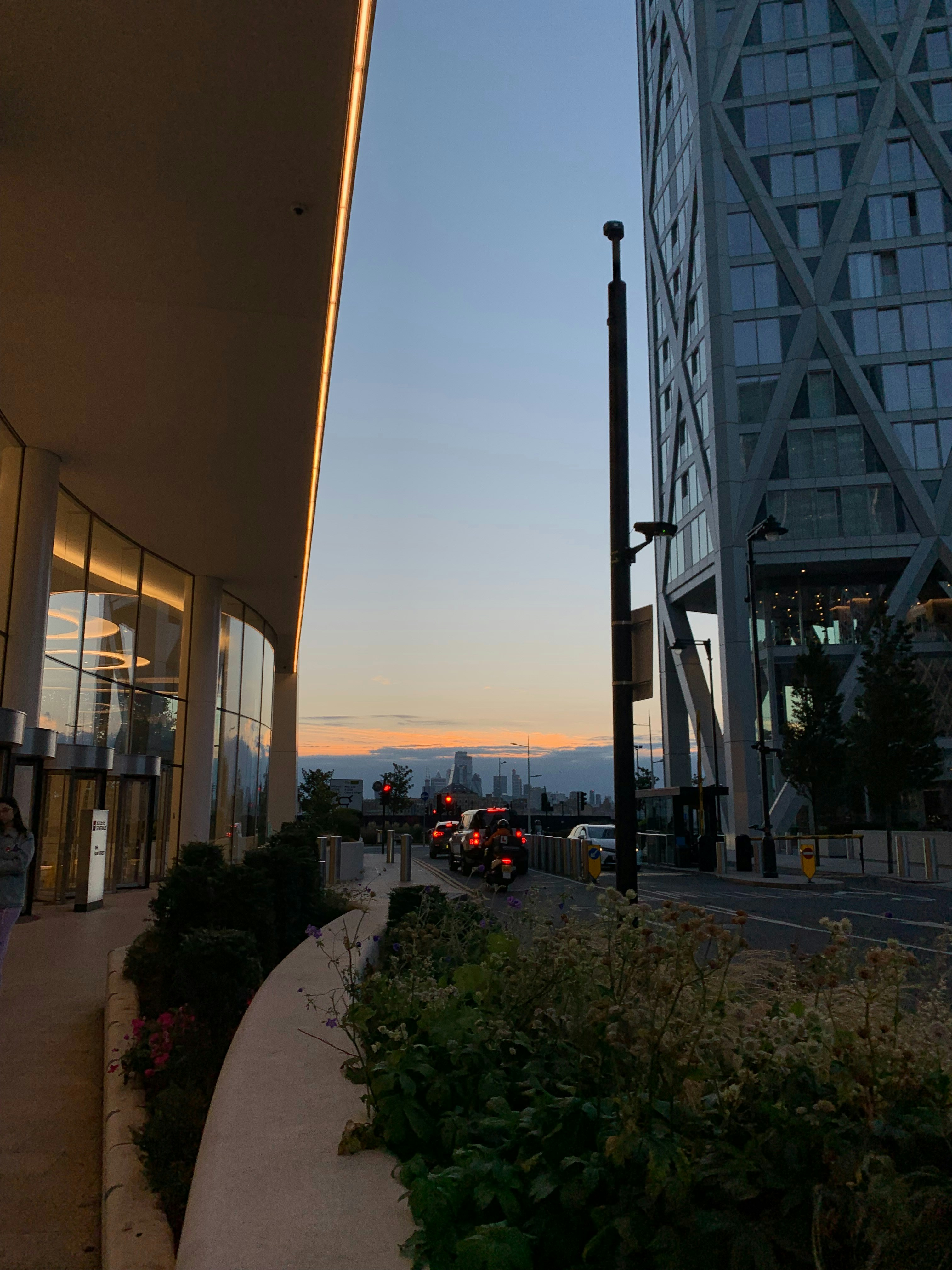 Crowded city skyline at dusk, dense urban buildings, busy traffic, grey concrete environment