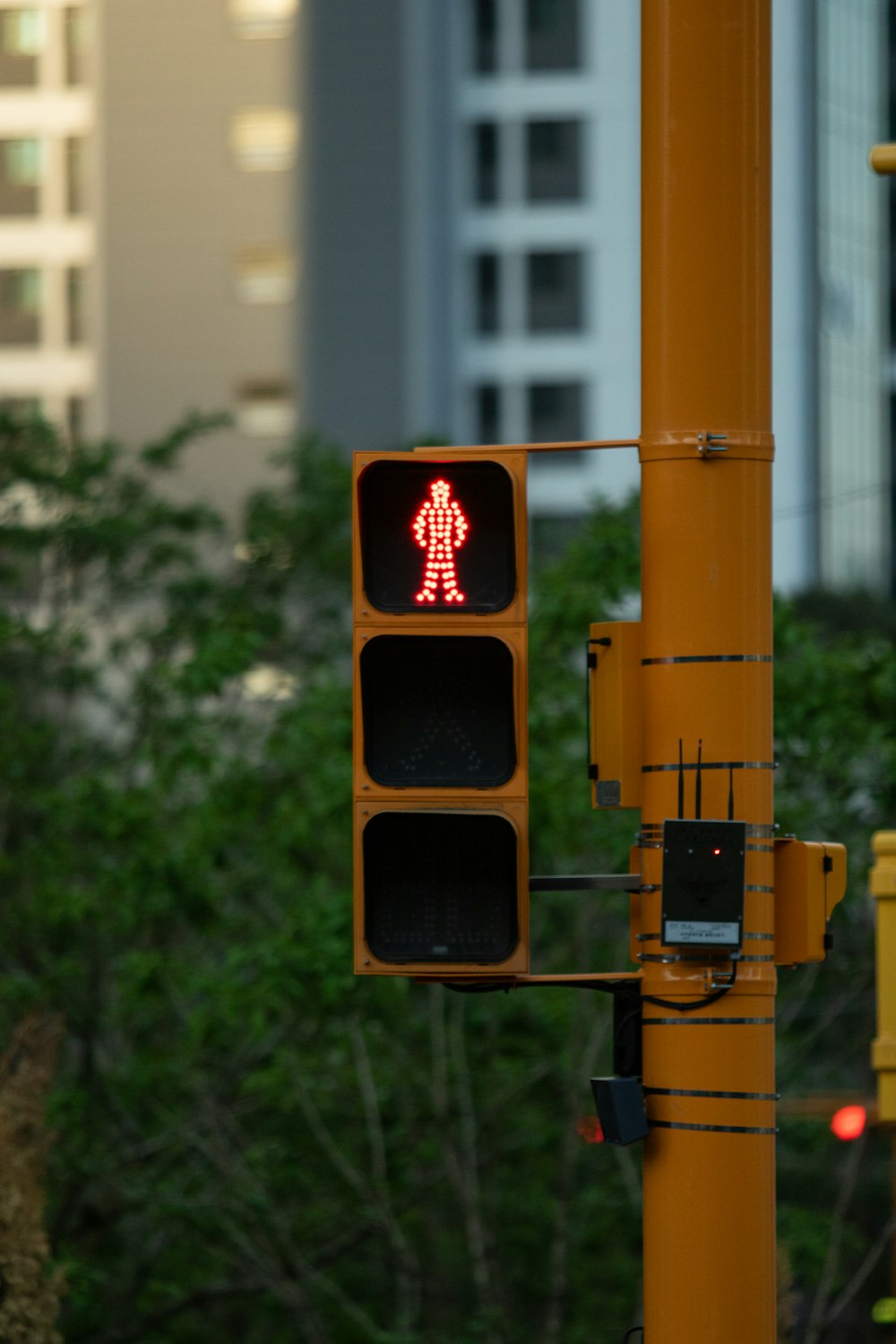 a traffic light with a red pedestrian sign on it