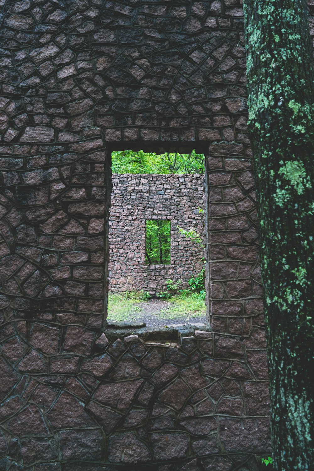 a stone building with a window in the middle of it