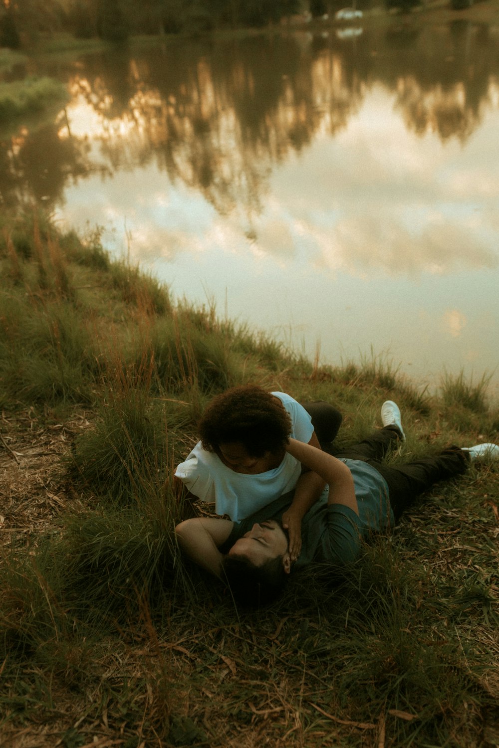 a couple of people that are sitting in the grass