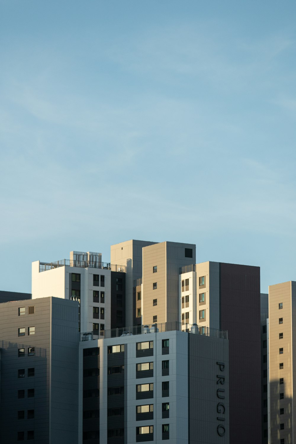 a view of a city with a plane flying in the sky