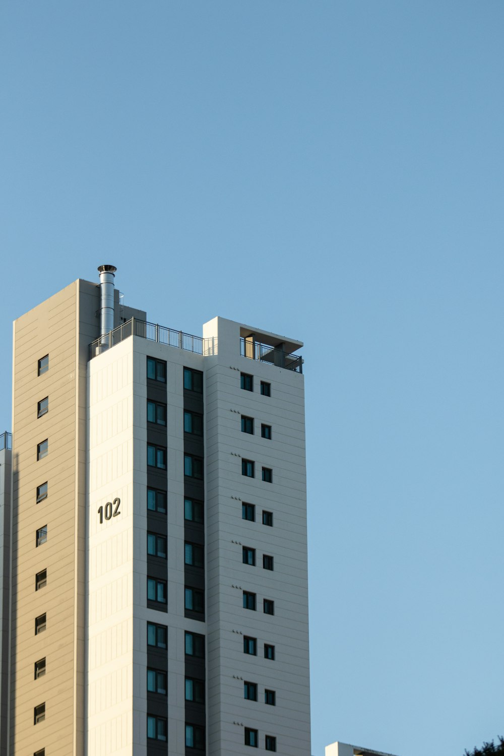 a tall white building with a sky background