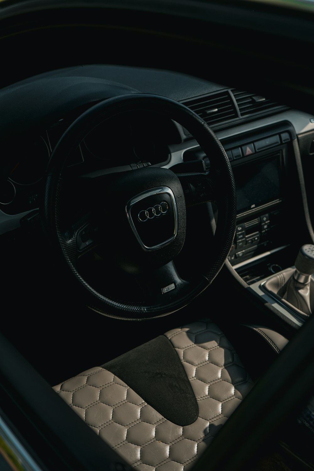 the interior of a car with a steering wheel and dashboard