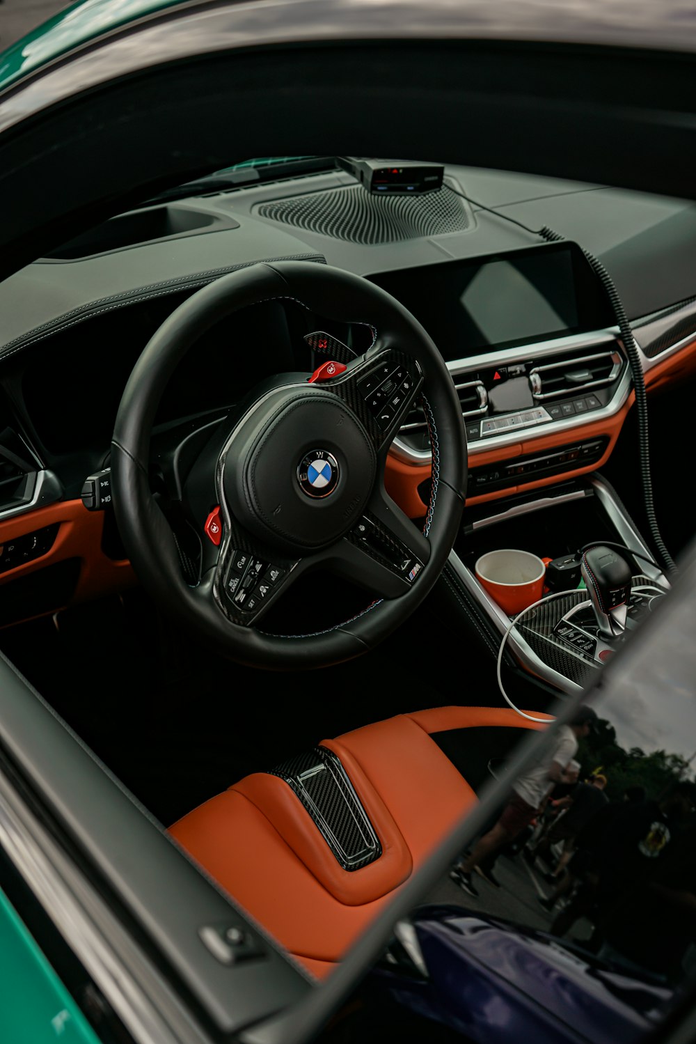 the interior of a sports car with orange and black leather