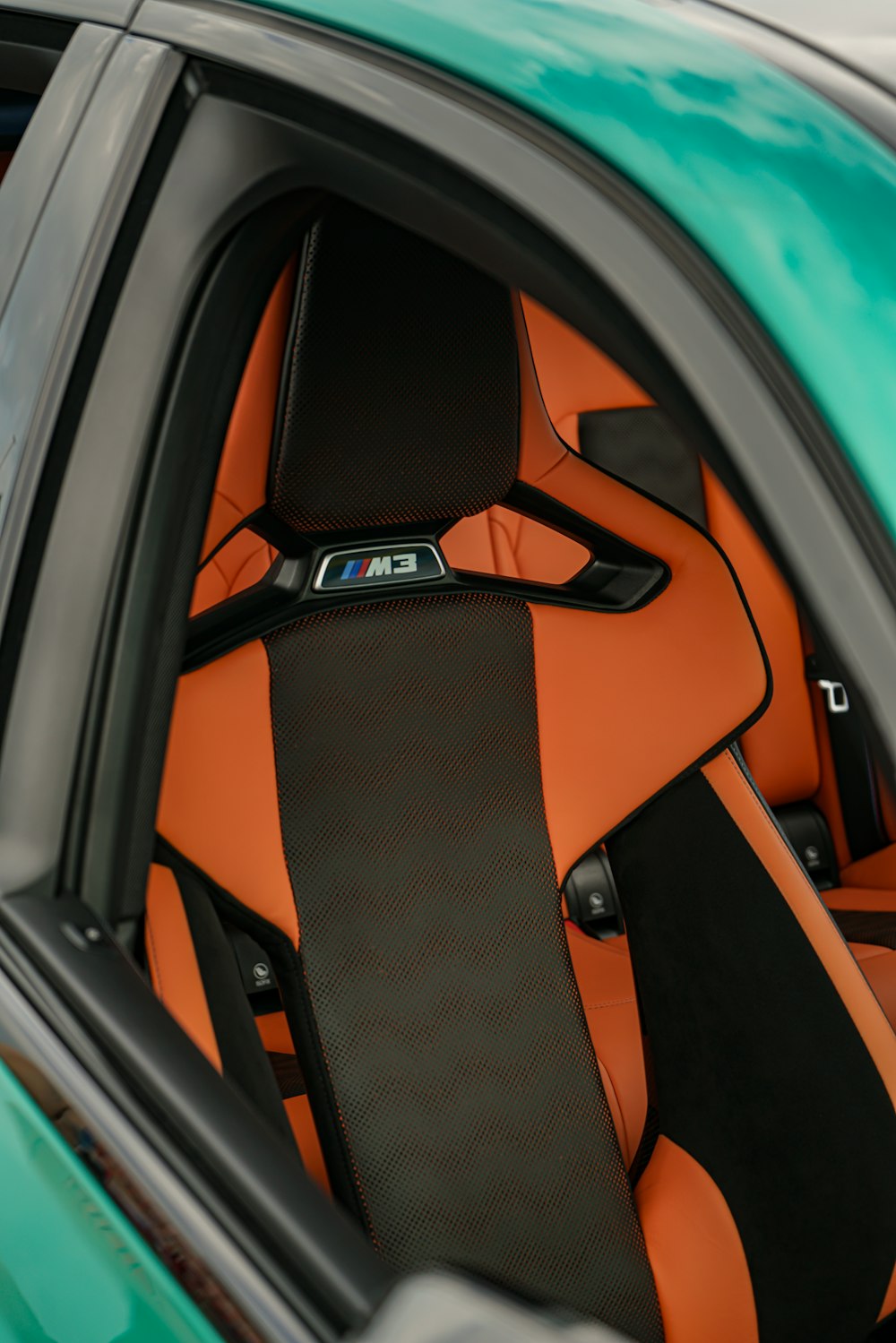 the interior of a sports car with orange and black seats