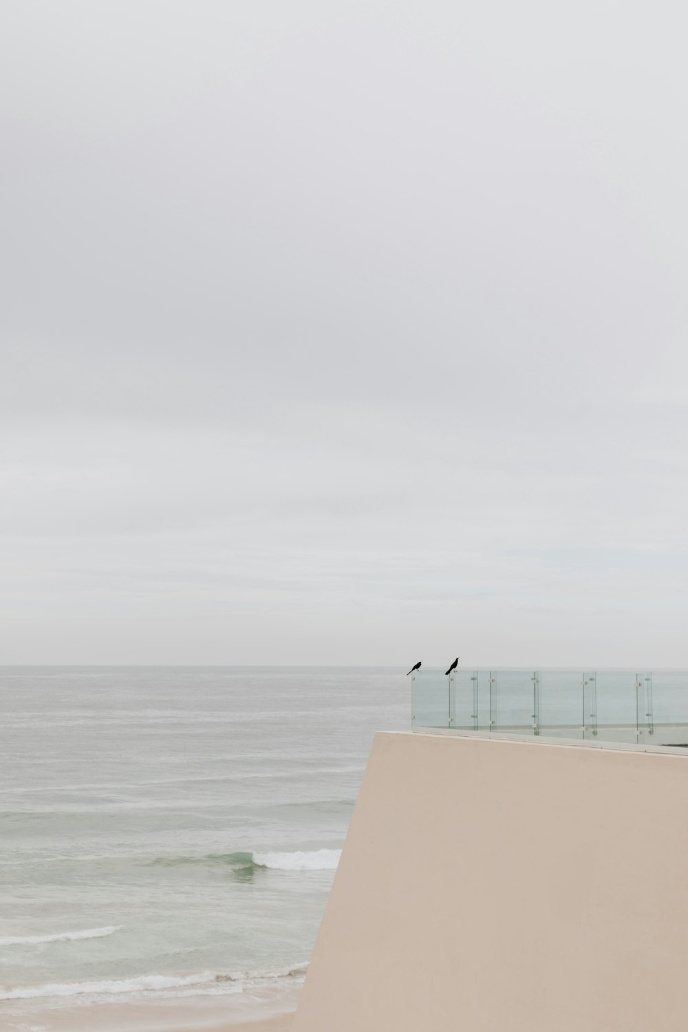 a person standing on a beach next to the ocean