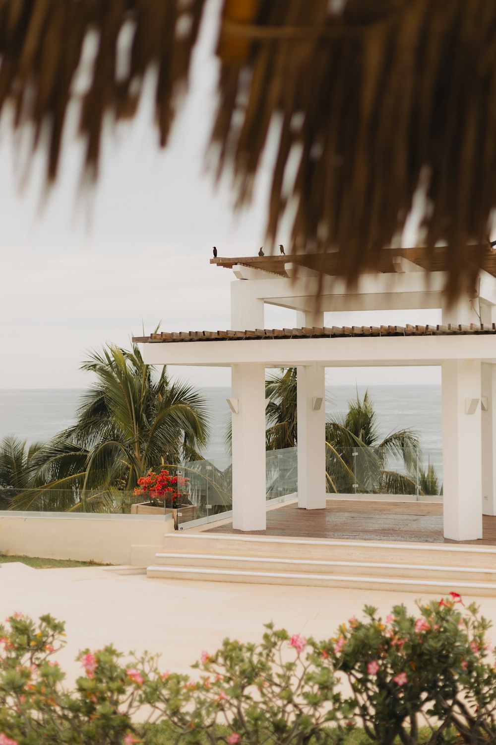 a gazebo with a view of the ocean in the background