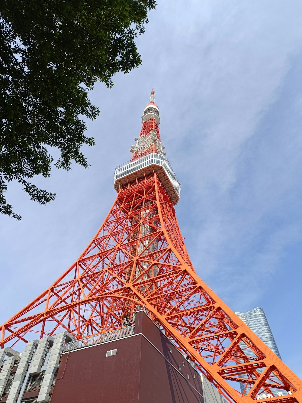 a tall orange tower with a sky background