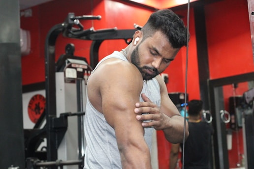 a man in a gym holding his hands together