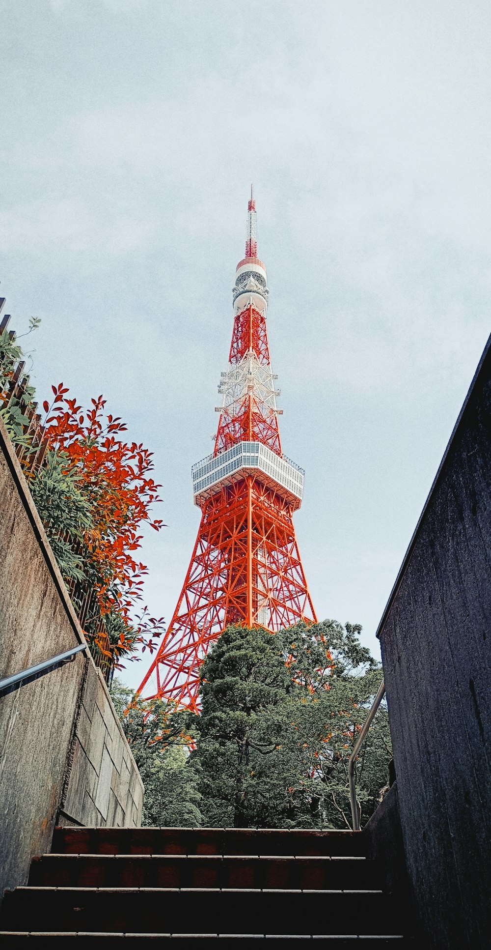 a very tall red tower towering over a city