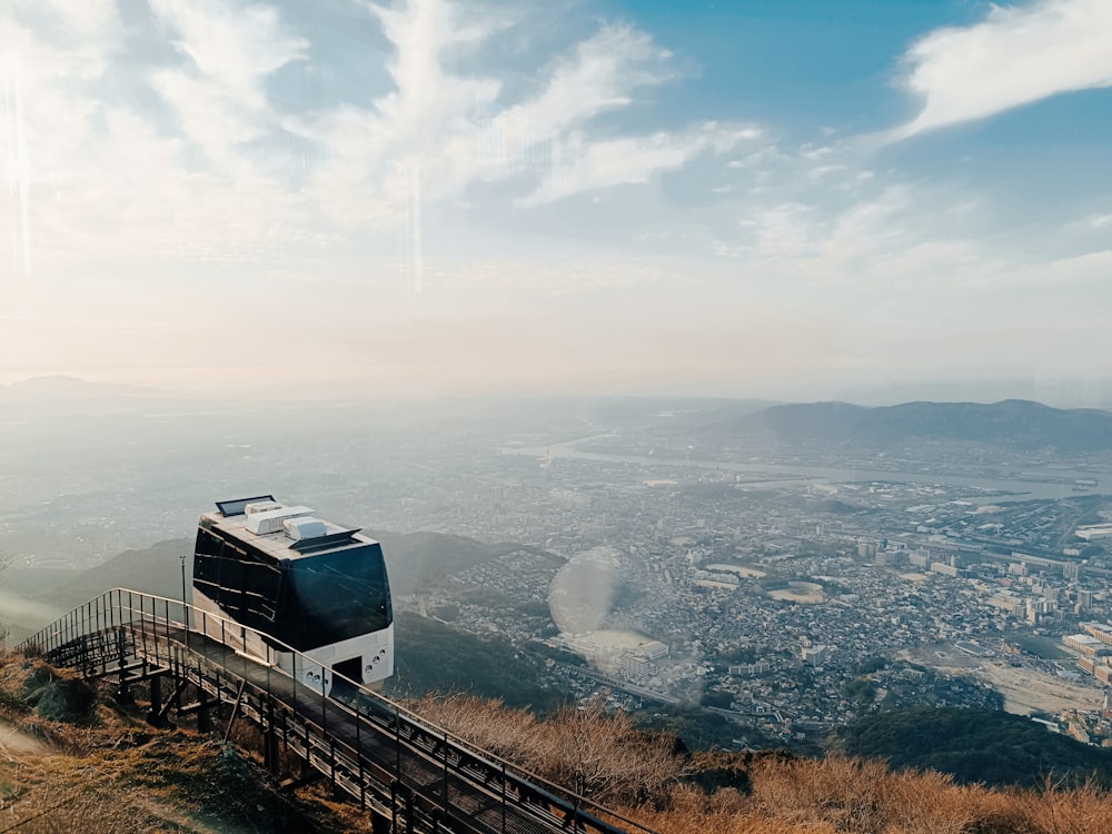 a cable car on a hill overlooking a city