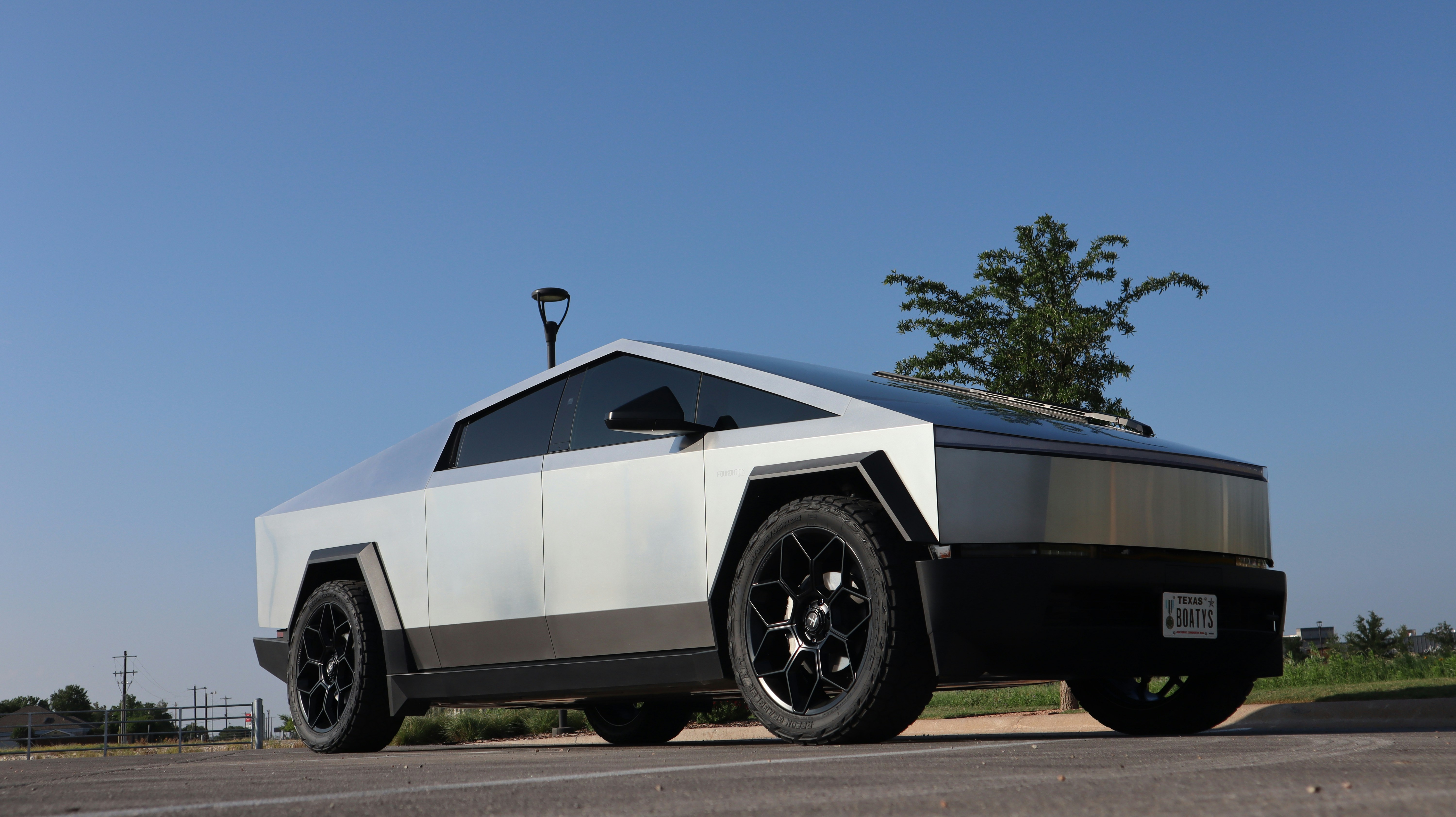 a futuristic car is parked on the side of the road