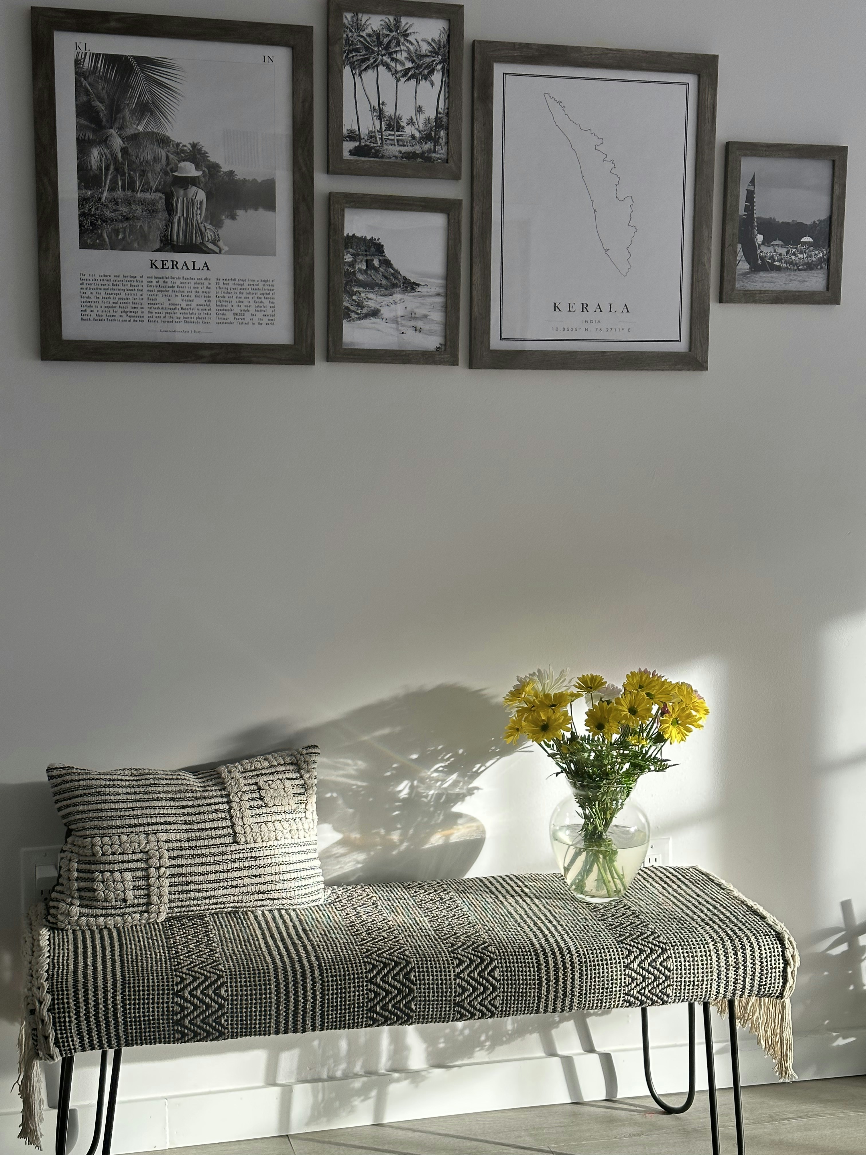a bench with a vase of yellow flowers on it