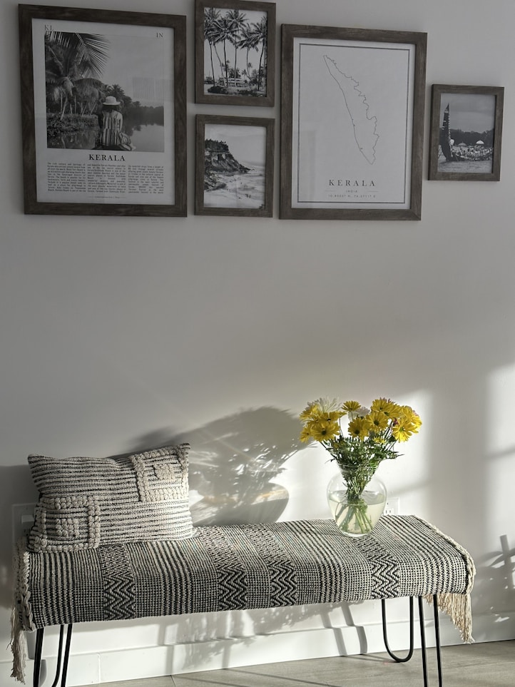 a bench with a vase of yellow flowers on it