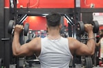 a man lifting a barbell in a gym