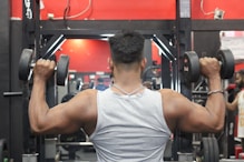 a man lifting a barbell in a gym