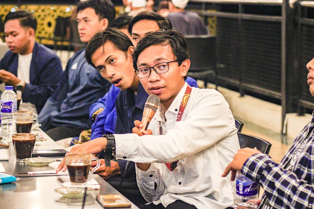 a group of people sitting at a table with drinks