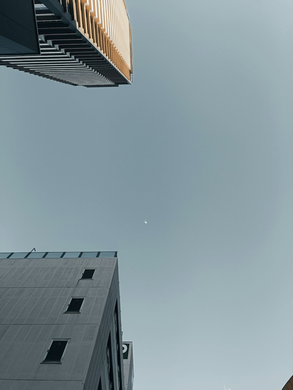 a tall building next to a very tall building