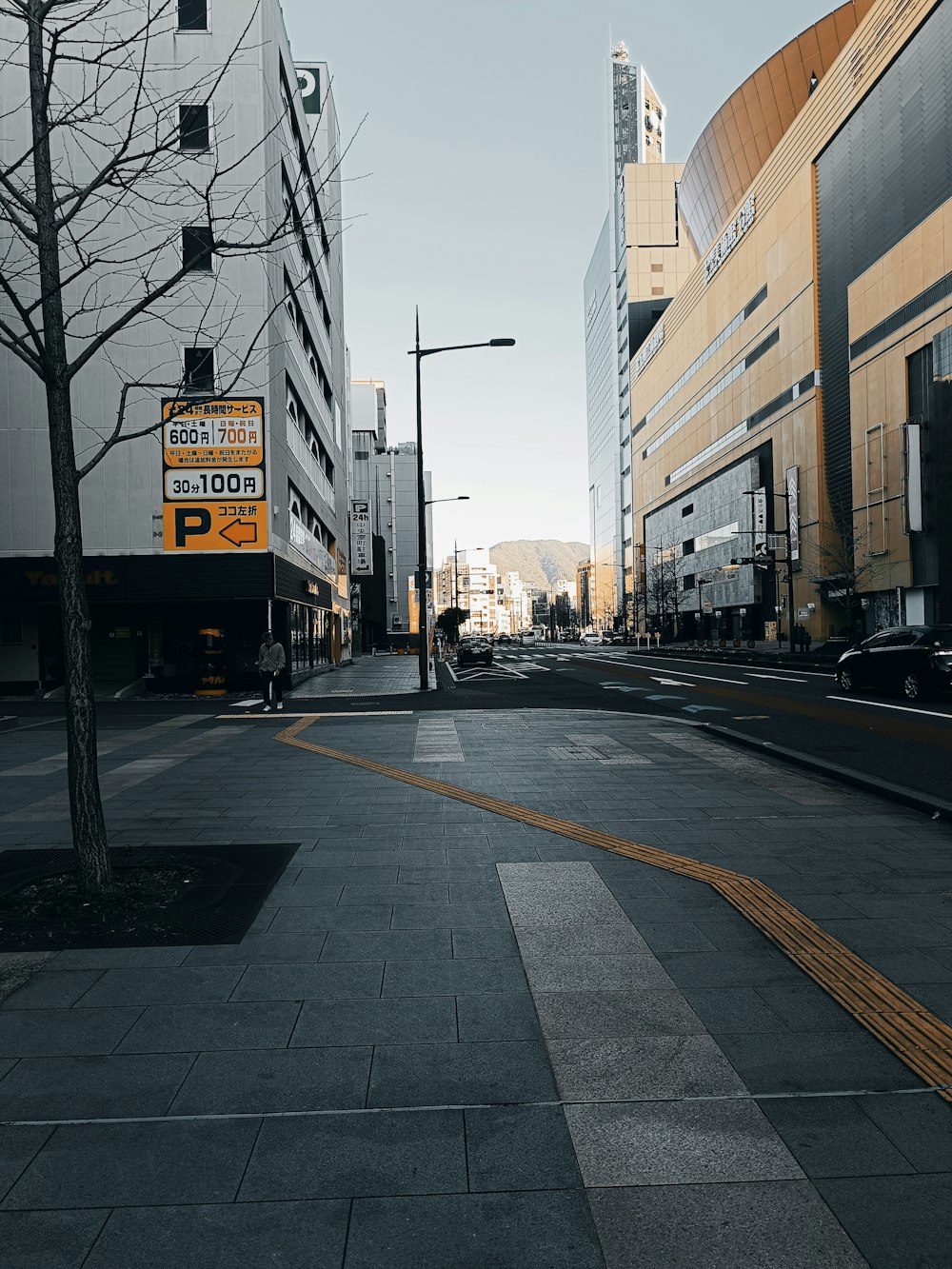 a city street with buildings and a street sign