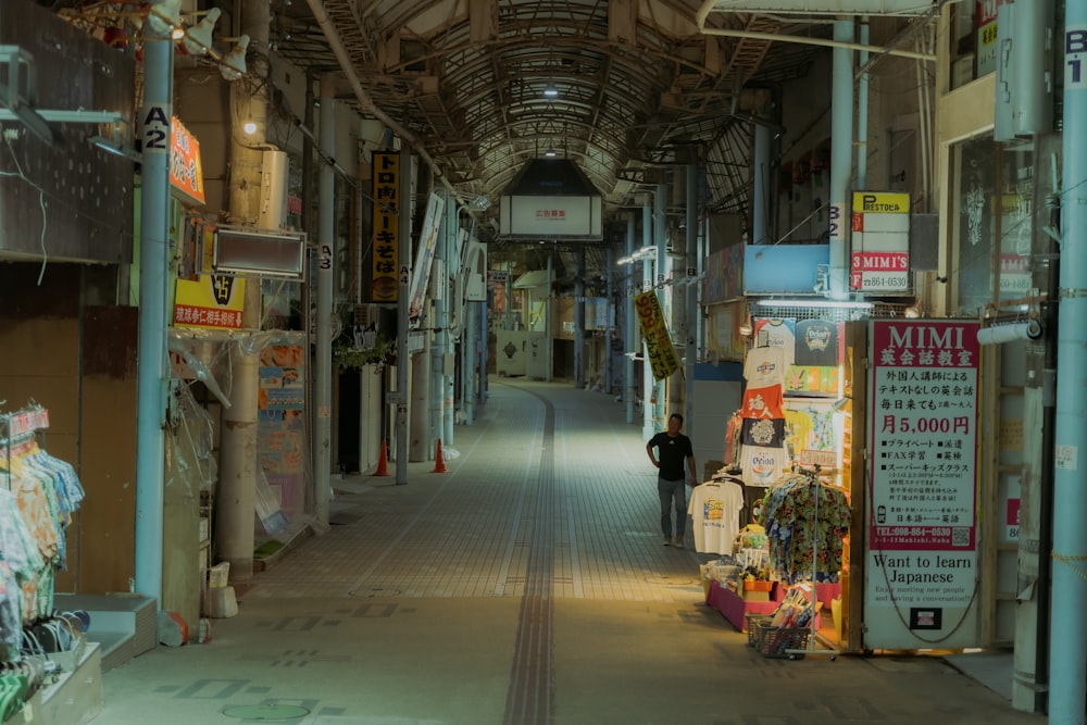 a narrow alley way with signs and signs on the walls