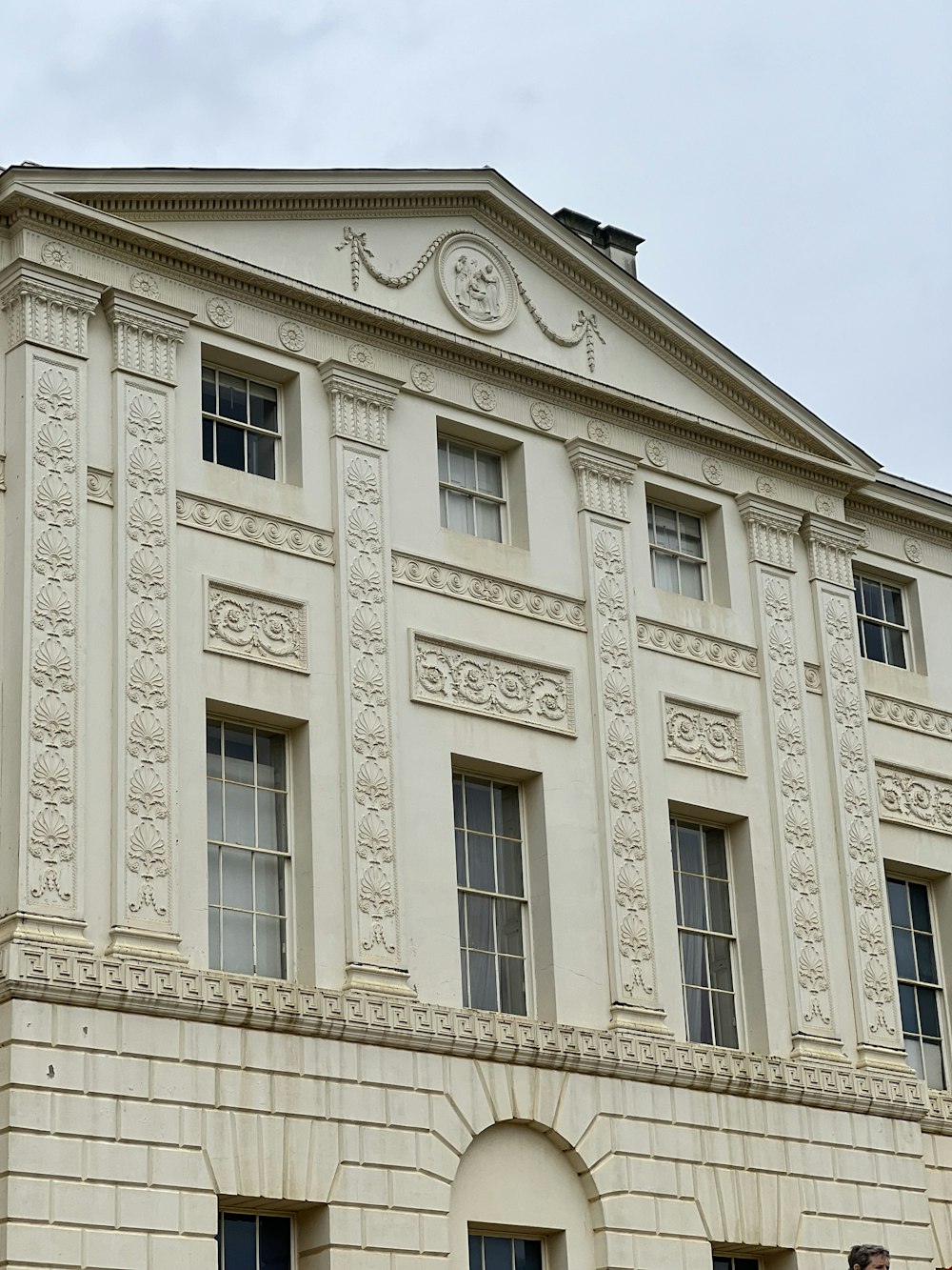 a large white building with a clock on the top of it