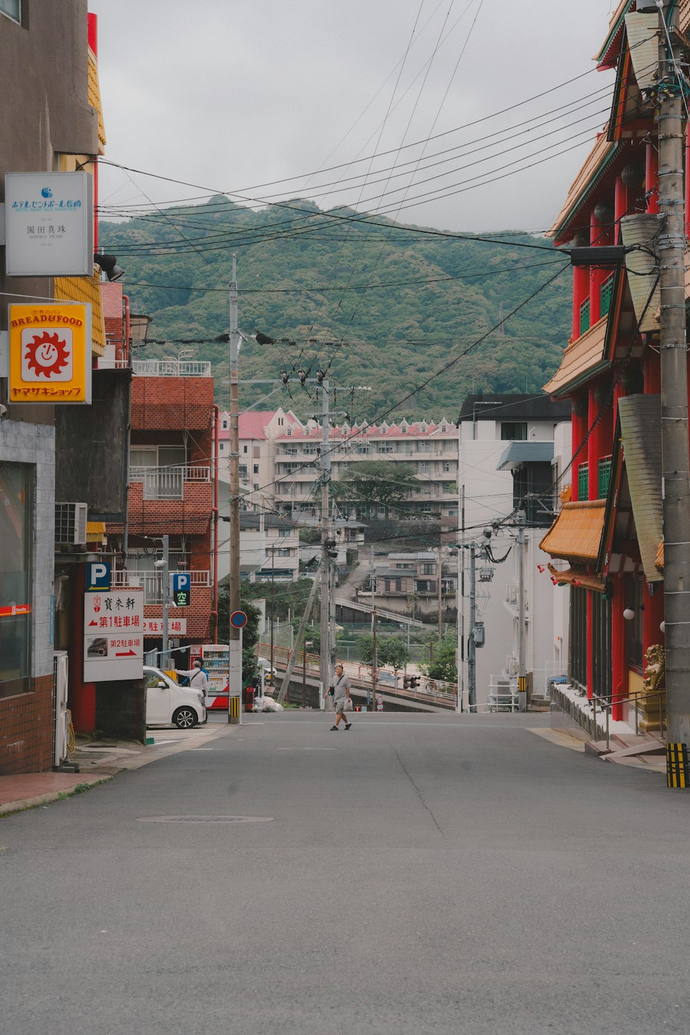 a city street with a mountain in the background